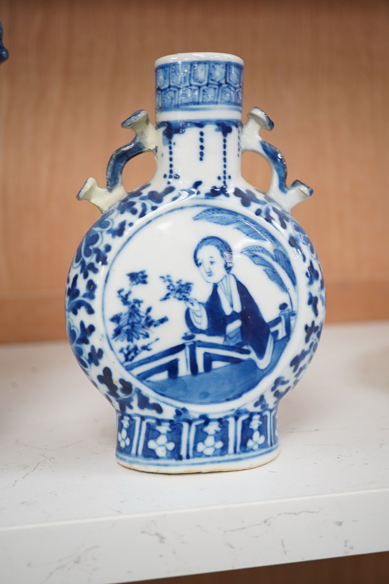 Late 19th century Chinese vases; pair of small Chinese blue and white moon flasks and a larger Chinese blue and white landscape vase, larger vase 22cm high. Condition - one moon flask handle restored, other items fair